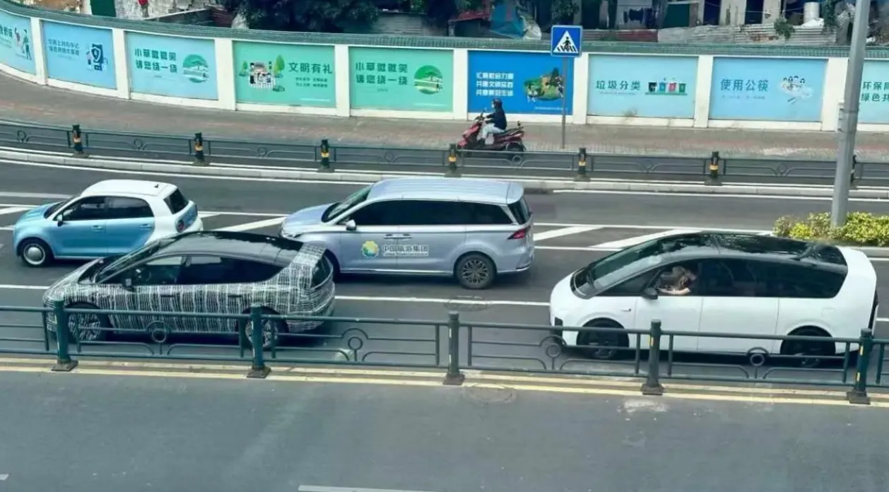 Li Auto's new fully electric M6 SUV spotted in camouflage in front of a Li MEGA